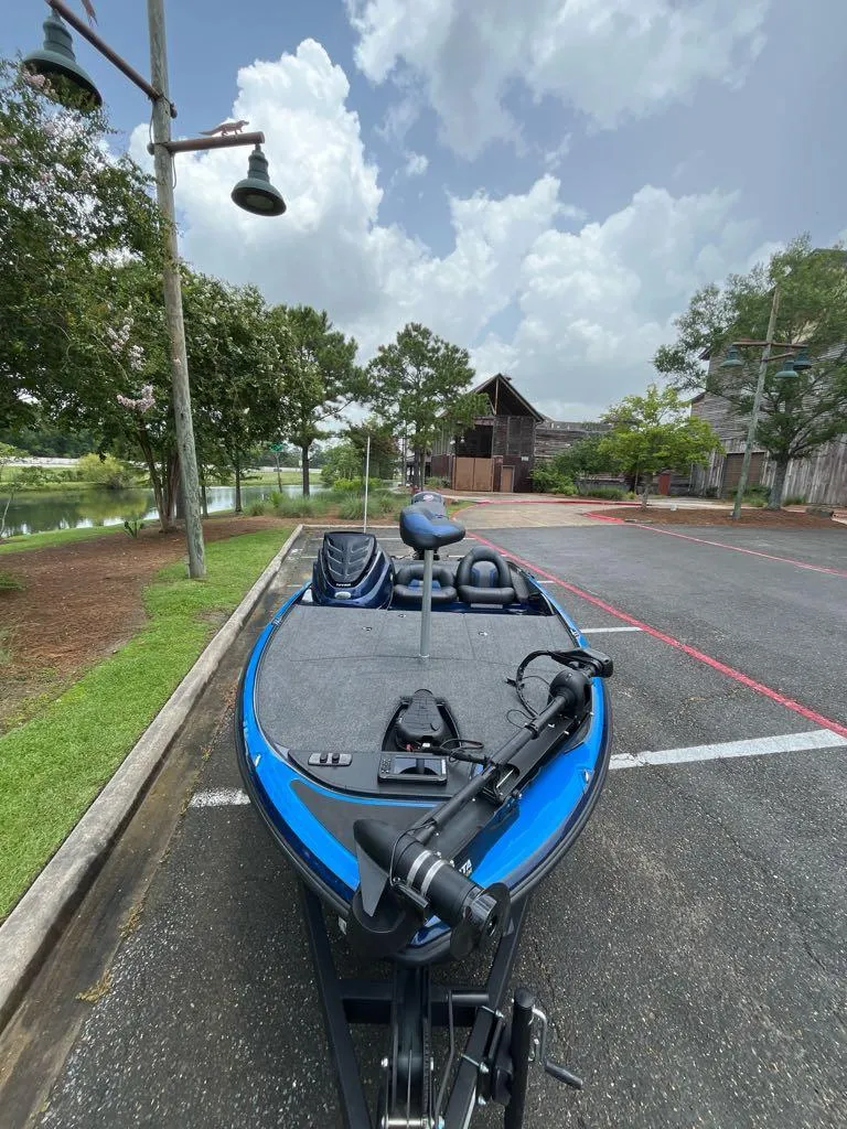 Slide: The Image of 2025 Nitro Z17 boat parked near a scenic lake under a cloudy sky. - 7
