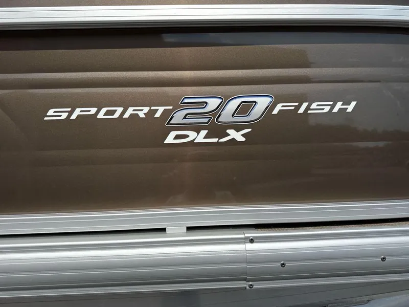 Slide: The Image of 2025 Sun Tracker SportFish 20 DLX logo on a metallic surface. - 2