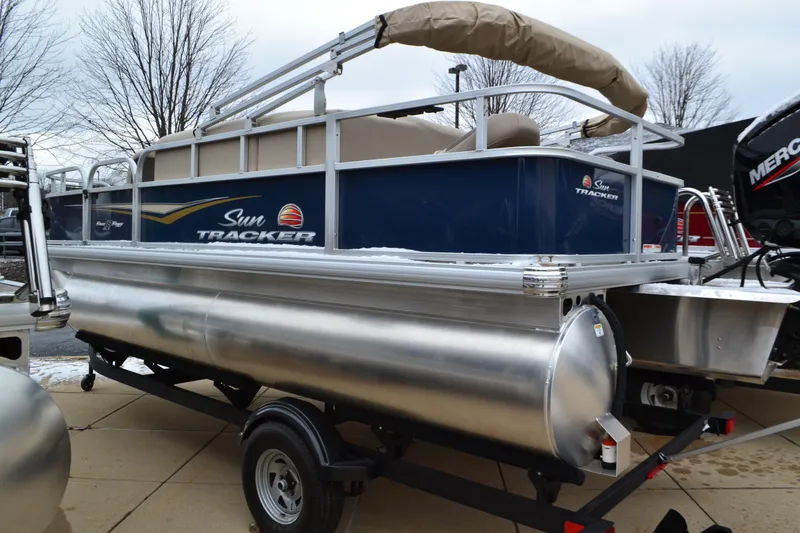 The Image of 2025 Sun Tracker Bass Buggy 18 DLX pontoon boat on trailer, outdoor display. - 0