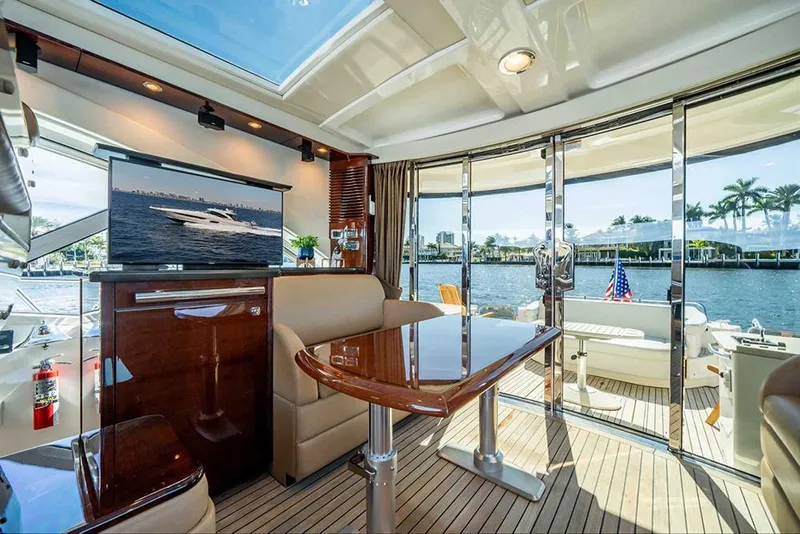 Slide: The Image of Luxurious interior of 2012 Sea Ray 610 Sundancer yacht with elegant seating and scenic water views. - 16