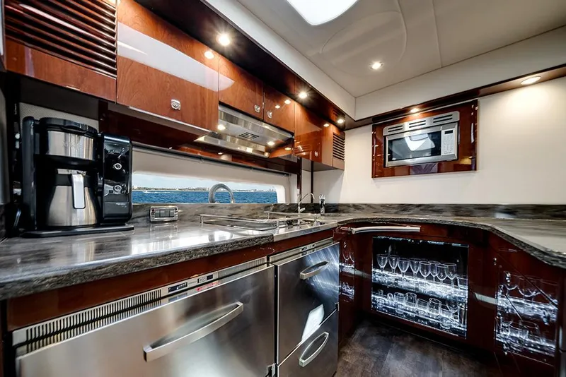 Slide: The Image of Luxurious kitchen interior of 2012 Sea Ray 610 Sundancer yacht with modern appliances. - 29