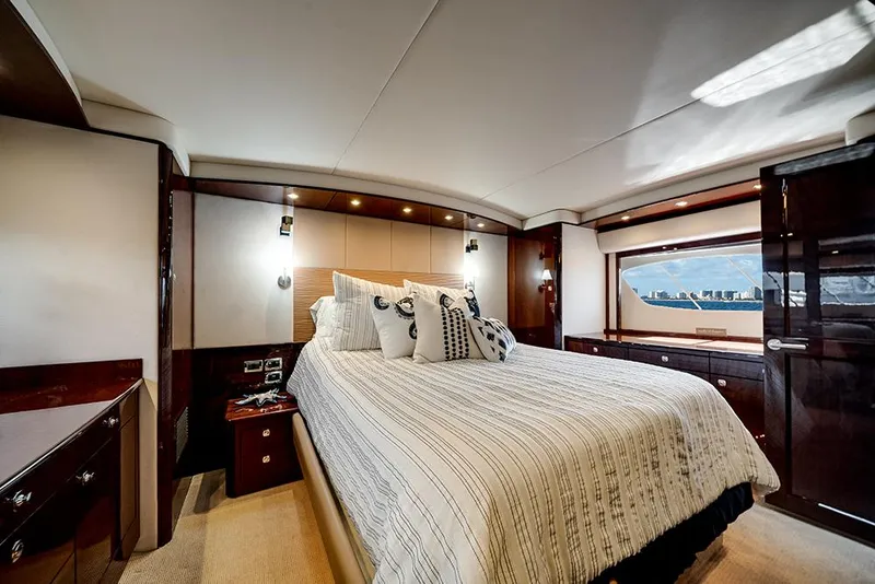 Slide: The Image of Luxurious bedroom interior of 2012 Sea Ray 610 Sundancer yacht with elegant bedding and wood accents. - 32