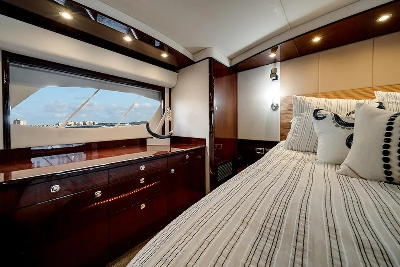 Slide: The Image of Luxurious cabin interior of 2012 Sea Ray 610 Sundancer yacht with elegant bedding and window view. - 35