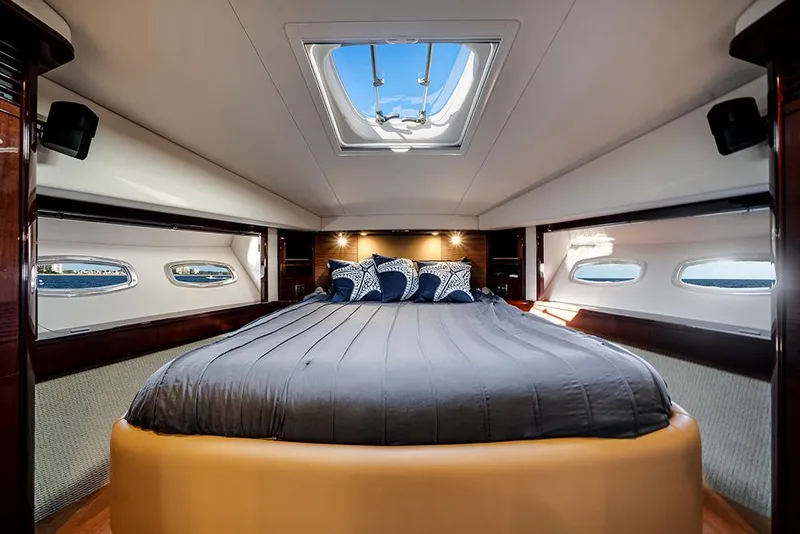 Slide: The Image of Luxurious bedroom interior of 2012 Sea Ray 610 Sundancer yacht with skylight and elegant bedding. - 38