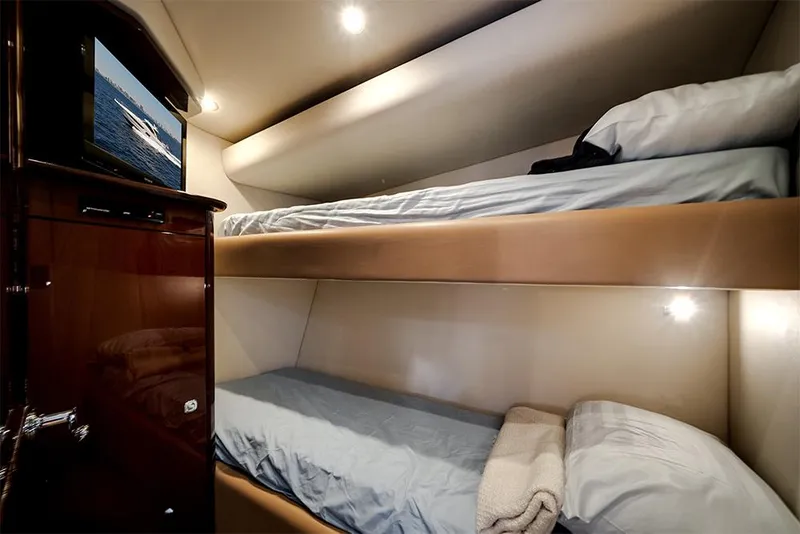 Slide: The Image of Interior of 2012 Sea Ray 610 Sundancer with cozy bunk beds and a TV. - 42