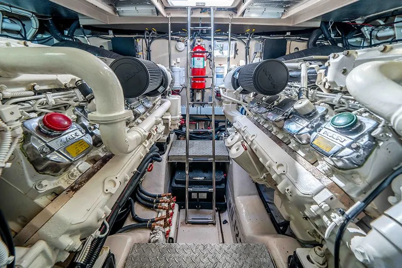 Slide: The Image of Engine room of 2012 Sea Ray 610 Sundancer yacht, featuring dual engines and safety equipment. - 44