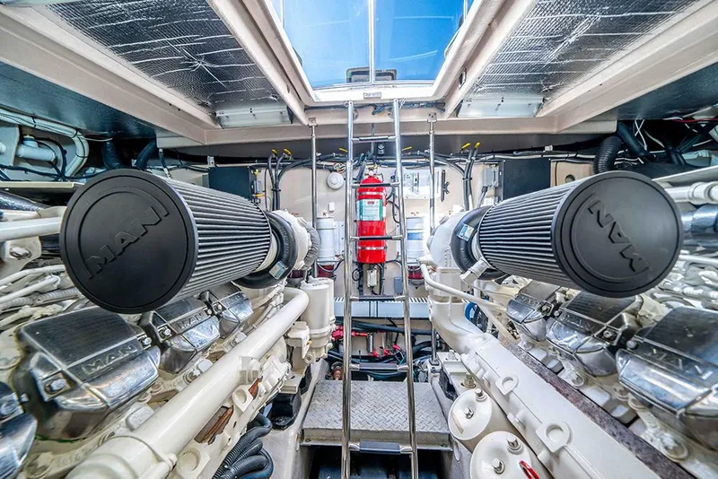 Slide: The Image of Engine room of 2012 Sea Ray 610 Sundancer yacht, featuring dual engines and safety equipment. - 45