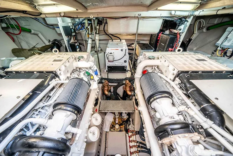 Slide: The Image of Engine room of 2012 Sea Ray 610 Sundancer yacht, showcasing dual engines and equipment. - 46