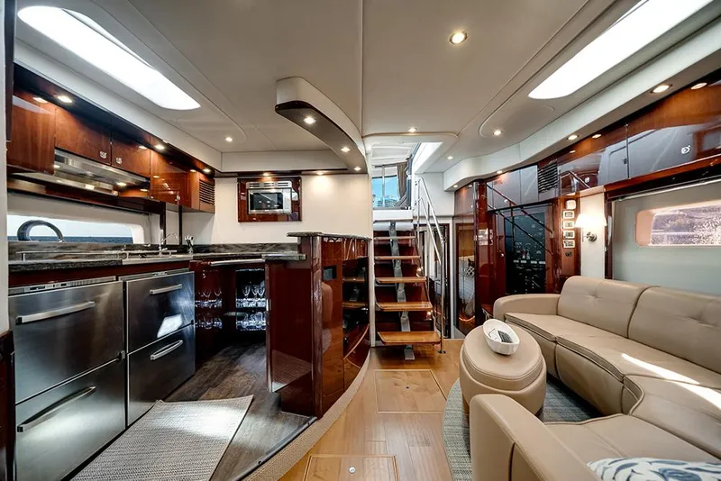 Slide: The Image of Luxurious interior of 2012 Sea Ray 610 Sundancer yacht with modern kitchen and seating area. - 6