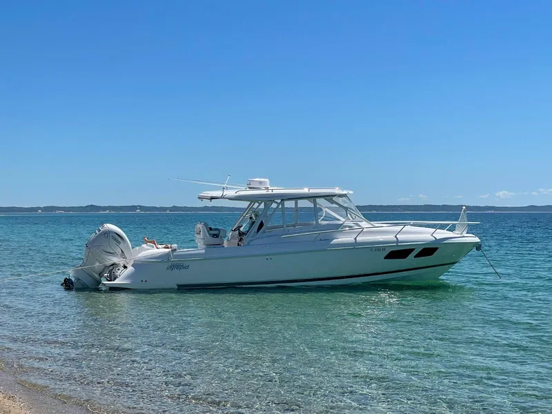 The Image of 2021 Intrepid 345 Valor boat on trailer in spacious indoor storage facility. - 0