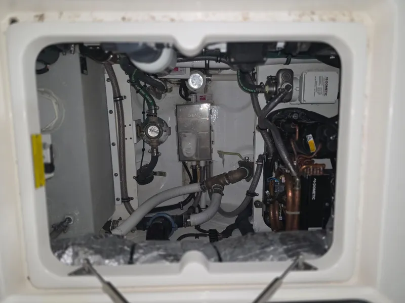 Slide: The Image of Engine compartment of a 2021 Intrepid 345 Valor boat, showcasing mechanical components and wiring. - 29