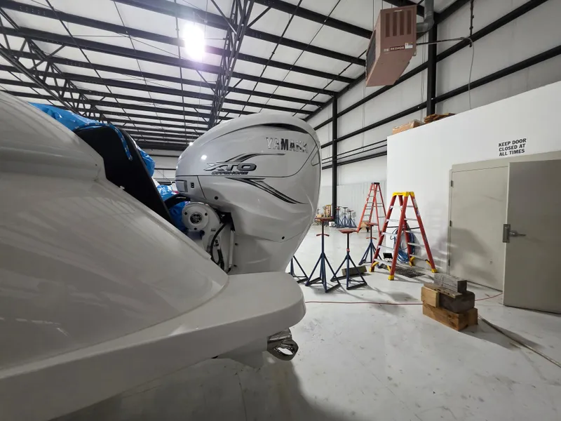 Slide: The Image of 2021 Intrepid 345 Valor boat with Yamaha XTO engine in a warehouse. - 31