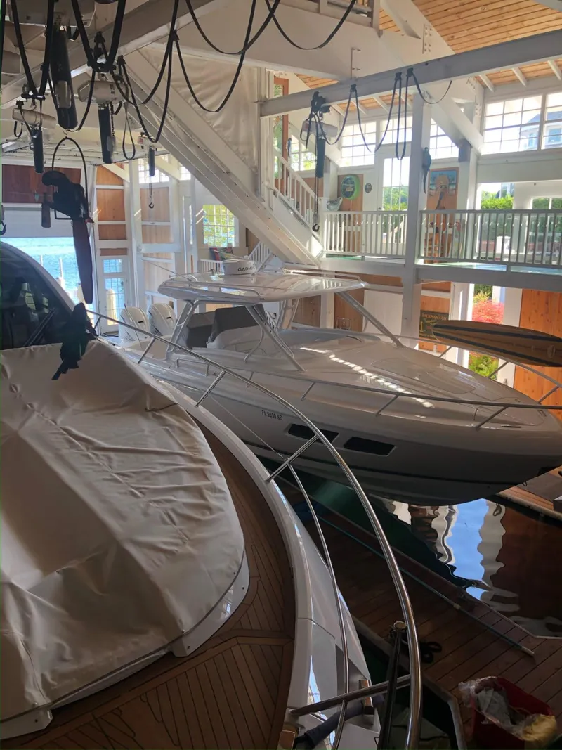 Slide: The Image of 2021 Intrepid 345 Valor boat docked indoors, showcasing sleek design and modern features. - 32