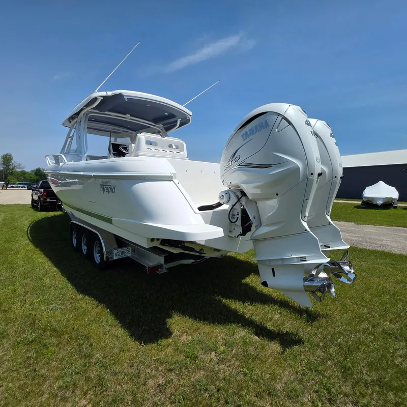 Slide: The Image of 2021 Intrepid 345 Valor boat with twin Yamaha engines on a grassy area. - 46