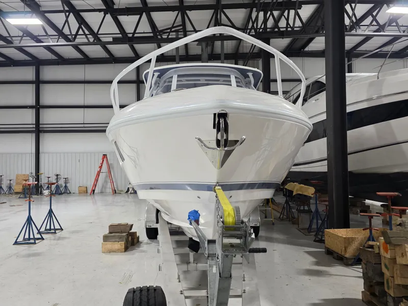 Slide: The Image of 2021 Intrepid 345 Valor boat in a warehouse, front view on trailer. - 6