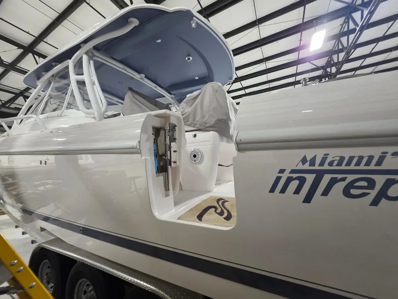 Slide: The Image of 2021 Intrepid 345 Valor boat in a warehouse, showcasing sleek design and branding. - 7