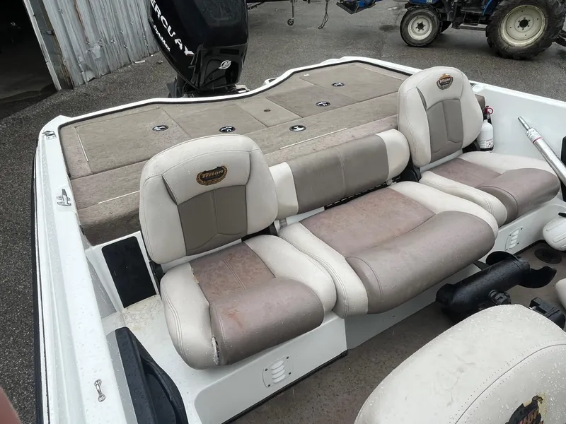 Slide: The Image of 2007 Triton SF-211 boat interior with cushioned seating and storage compartments. - 8