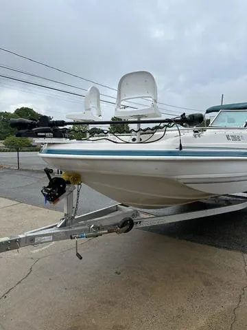 Slide: The Image of 2001 Hurricane 237 Sun Deck boat on trailer, parked outdoors on a cloudy day. - 8