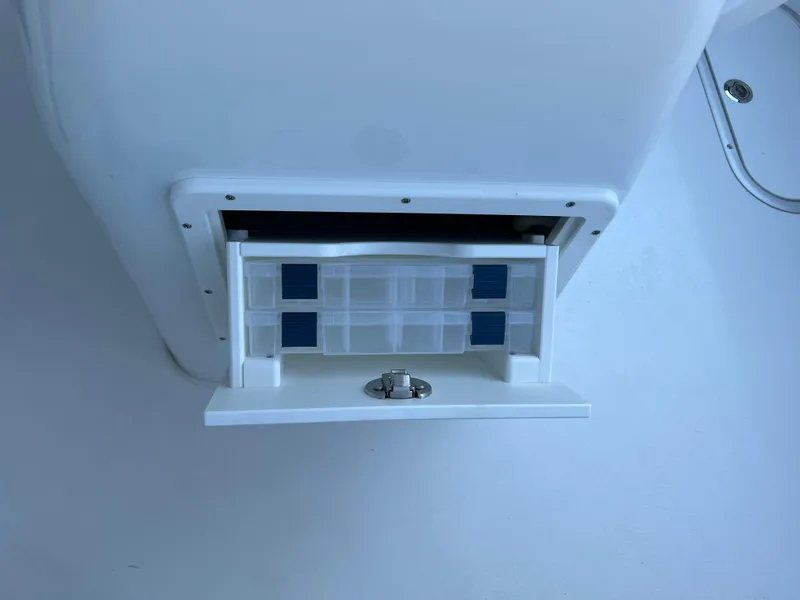 Slide: The Image of Storage compartment on 2026 Cape Horn 24XS boat, featuring organized tackle boxes. - 15