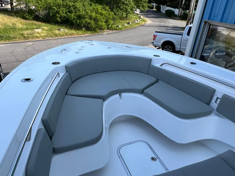 Slide: The Image of 2026 Cape Horn 24XS boat with spacious gray seating area, docked outdoors. - 6