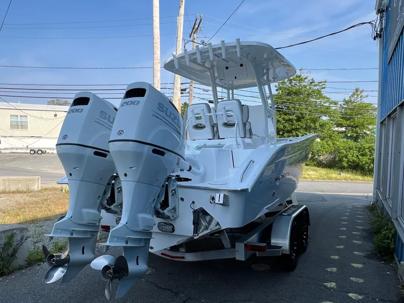 Slide: The Image of 2026 Cape Horn 24XS boat with dual Suzuki engines on a trailer. - 2