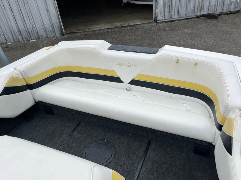 Slide: The Image of 1990 Correct Craft Ski Nautique boat interior with white and yellow seating. - 6