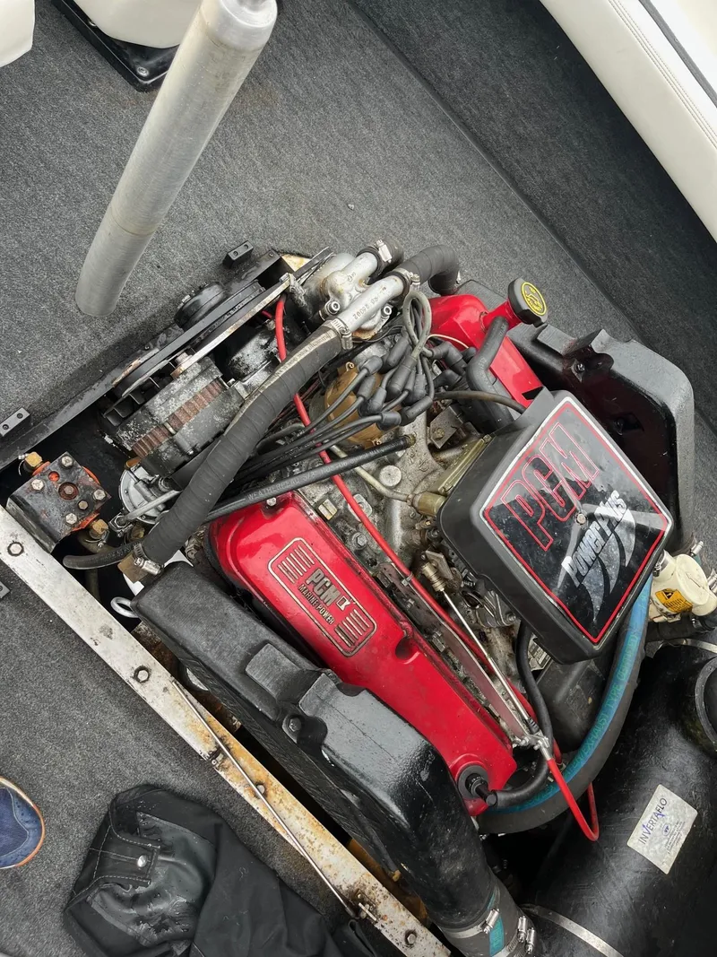 Slide: The Image of 1990 Correct Craft Ski Nautique engine with red components and visible wiring. - 8