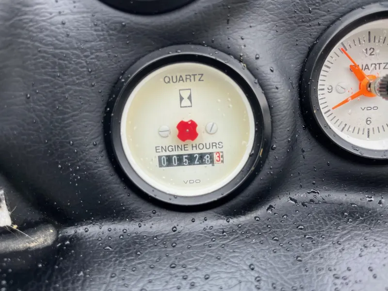 Slide: The Image of 1990 Correct Craft Ski Nautique engine hour meter showing 528.3 hours, with raindrops on the surface. - 9