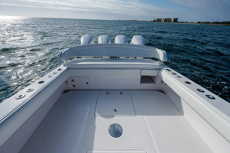 Slide: The Image of 2013 Bahama Quad V10's boat deck on open water, clear sky, and distant shoreline. - 11
