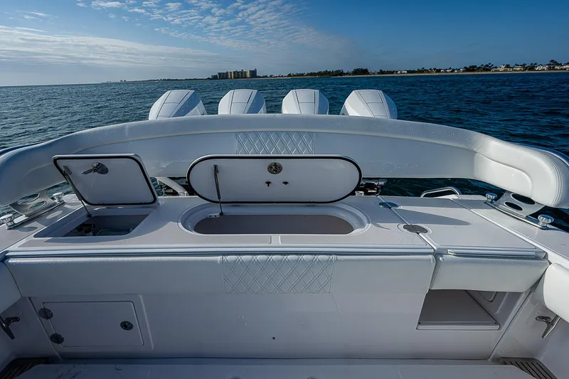 Slide: The Image of 2013 Bahama Quad V10's boat interior with open compartments, ocean view. - 12