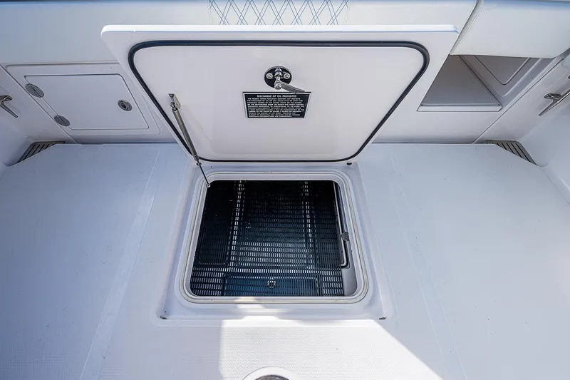 Slide: The Image of Open hatch on 2013 Bahama Quad V10's boat deck, showcasing storage compartment. - 13