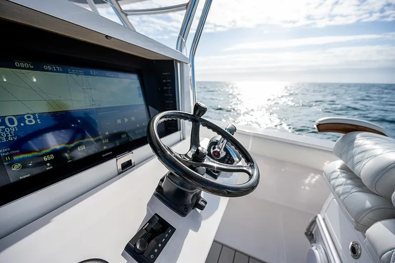 Slide: The Image of Steering console of 2013 Bahama Quad V10's boat with ocean view. - 18