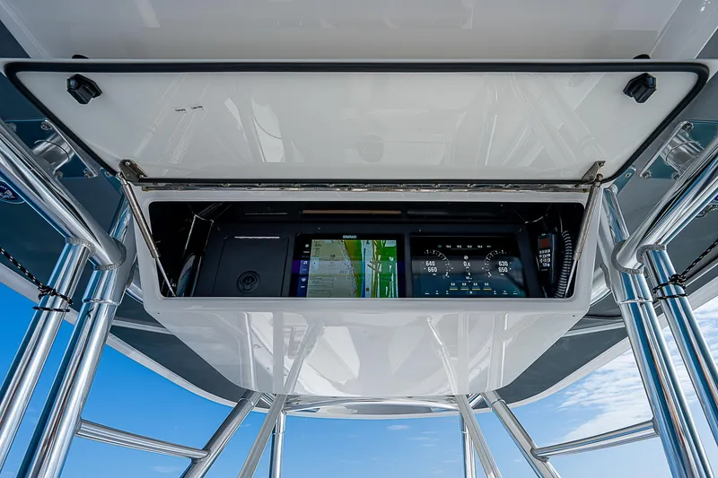 Slide: The Image of 2013 Bahama Quad V10's boat console with navigation screens and controls. - 19