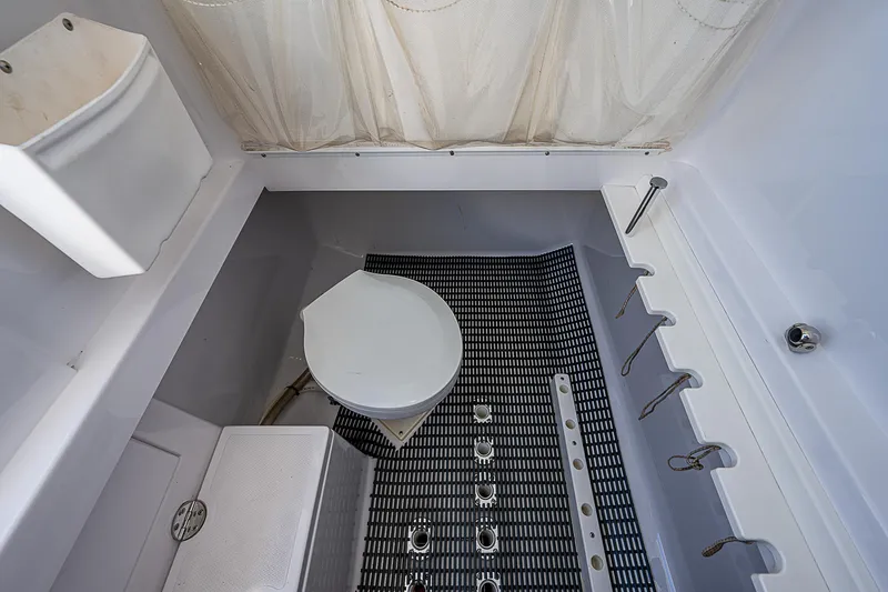 Slide: The Image of 2013 Bahama Quad V10's boat interior with toilet and shower area. - 25