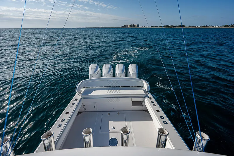 Slide: The Image of Bahama Quad V10's 2013 boat cruising on open water, clear sky, and distant shoreline. - 27