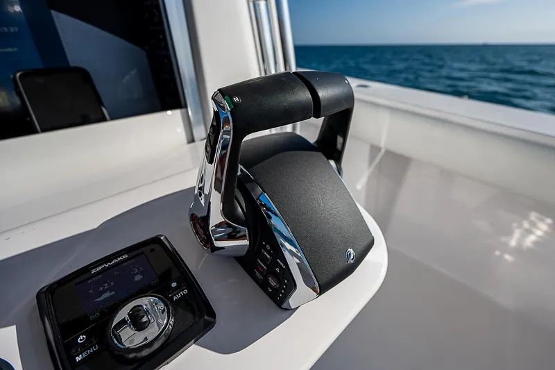 Slide: The Image of Boat throttle controls on a 2013 Bahama Quad V10's, ocean in background. - 29