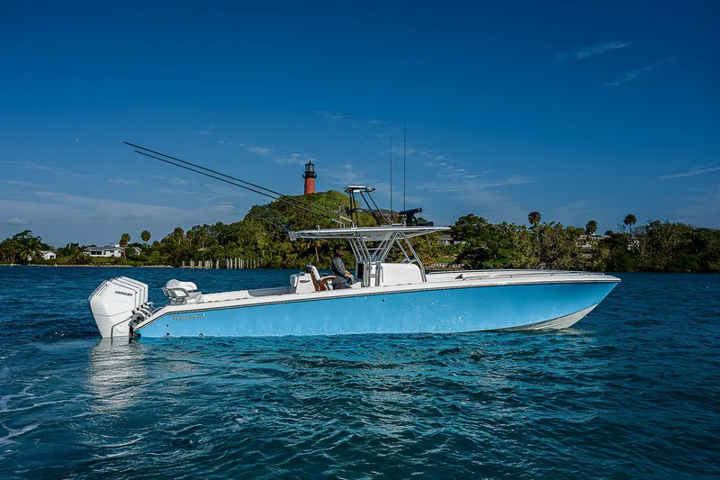 Slide: The Image of 2013 Bahama Quad V10's boat on blue water with lighthouse in background. - 30