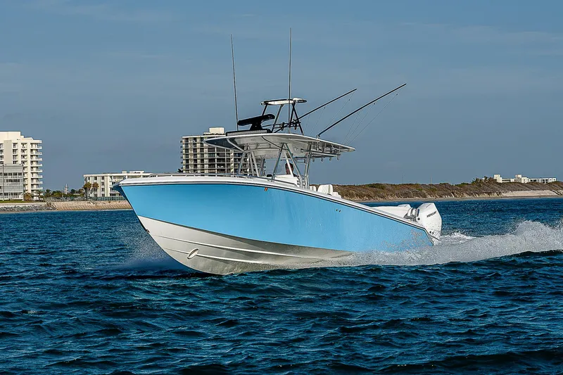 Slide: The Image of 2013 Bahama Quad V10's boat cruising on ocean near coastal buildings. - 33