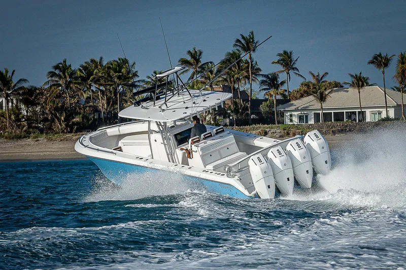 Slide: The Image of 2013 Bahama Quad V10's boat cruising on ocean near tropical shoreline. - 37