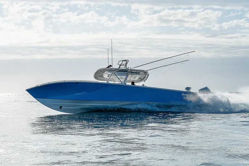 Slide: The Image of 2013 Bahama Quad V10's speedboat cruising on open water under a cloudy sky. - 38