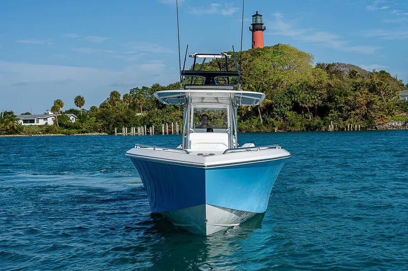 Slide: The Image of 2013 Bahama Quad V10's boat cruising near a lighthouse on a sunny day. - 4