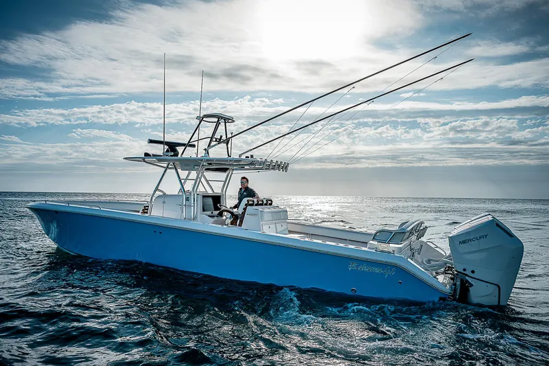 Slide: The Image of 2013 Bahama Quad V10's boat cruising on open ocean under a cloudy sky. - 40