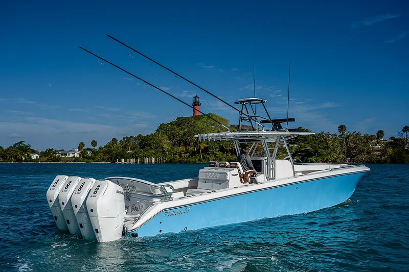Slide: The Image of 2013 Bahama Quad V10's boat on water with lighthouse in background. - 5