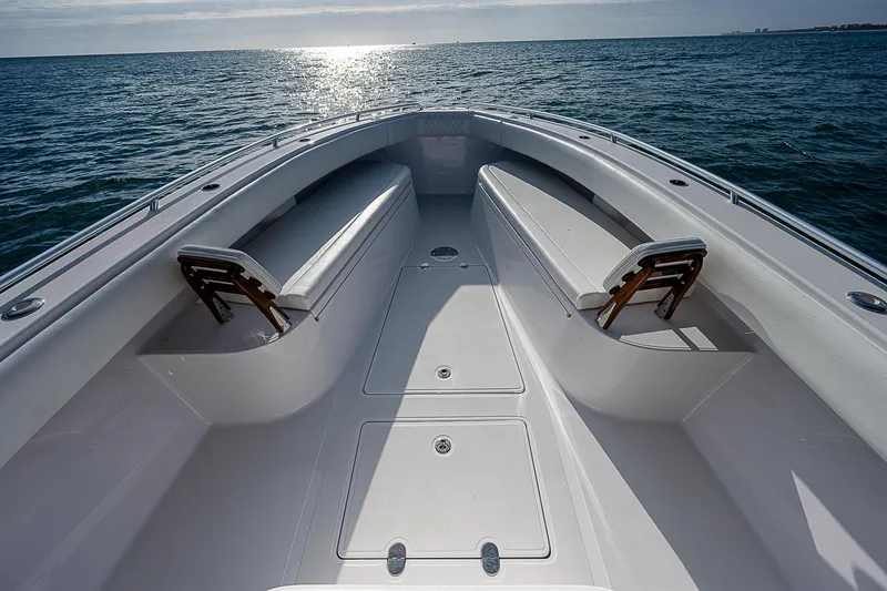 Slide: The Image of 2013 Bahama Quad V10's boat deck with seating, overlooking the ocean at sunset. - 6