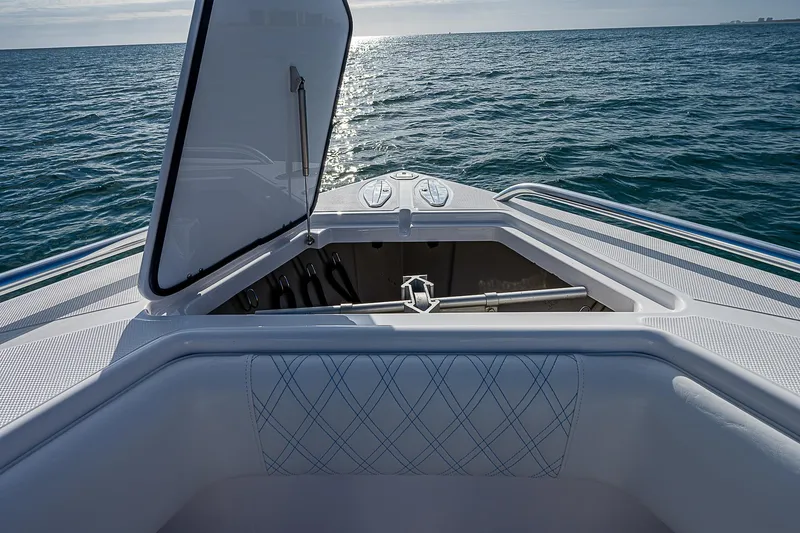 Slide: The Image of 2013 Bahama Quad V10's boat with open storage compartment on calm ocean. - 8