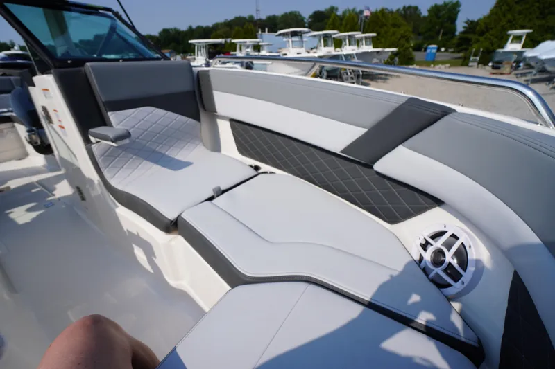 Slide: The Image of 2025 Chaparral 267 SSX boat interior with open storage compartments and seating. - 23