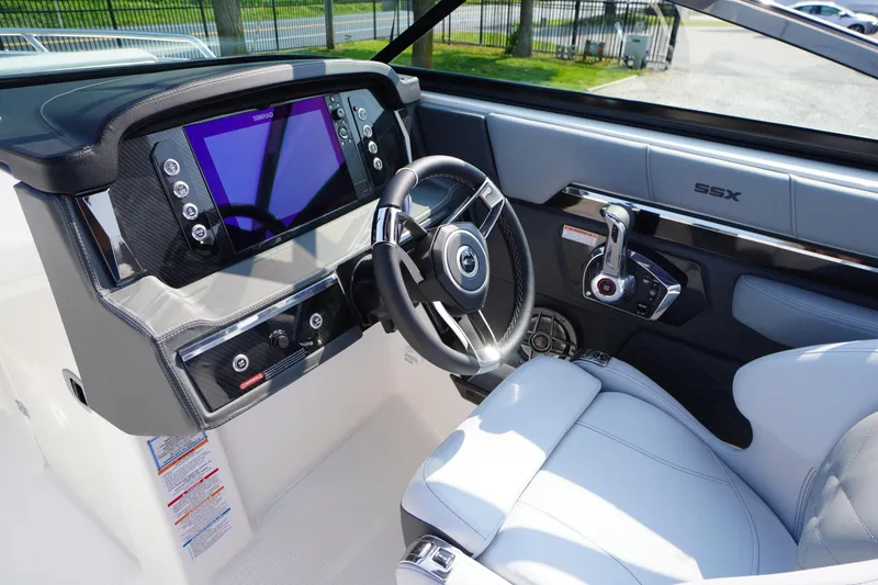 Slide: The Image of Interior of 2025 Chaparral 267 SSX boat, featuring sleek controls and speaker system. - 29
