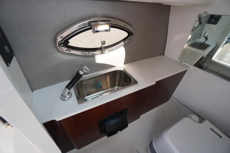 Slide: The Image of 2025 Chaparral 267 SSX boat interior with sink and compact toilet. - 43