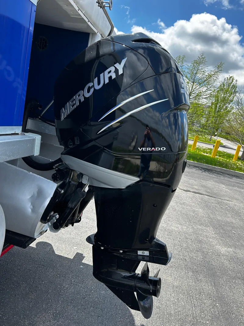 Slide: The Image of Outboard motor on Evolution 26 boat, 2005 model, parked outdoors. - 11
