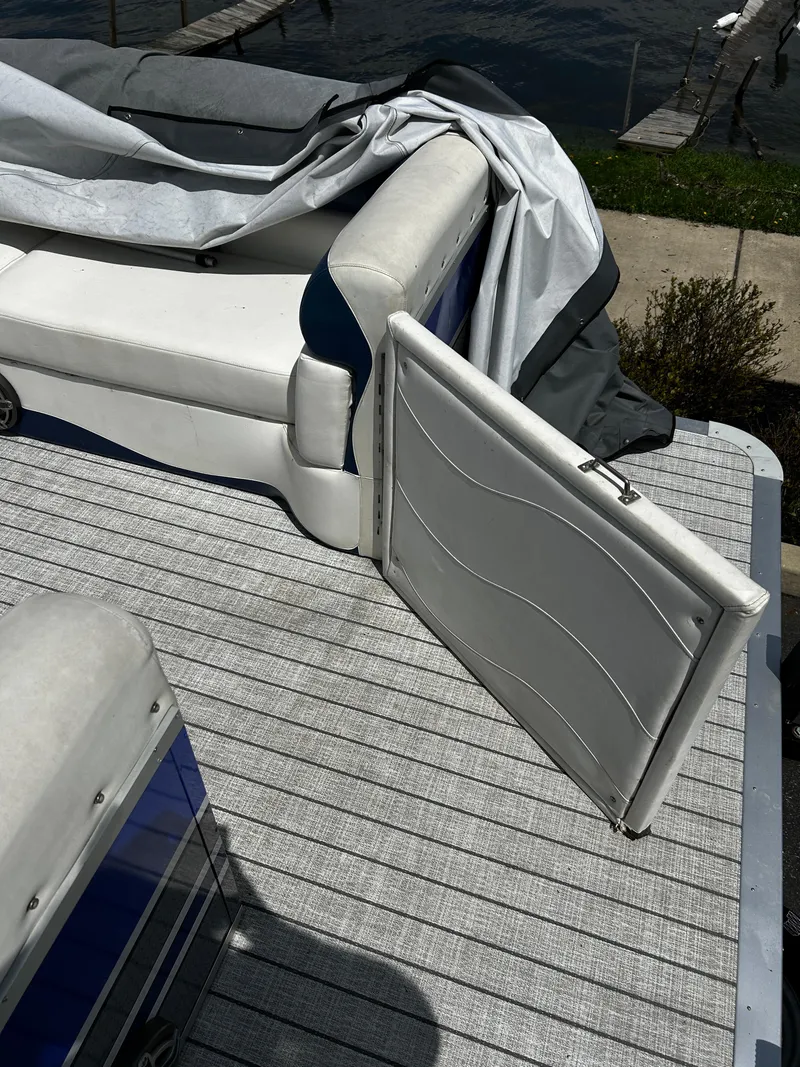 Slide: The Image of 2005 Evolution 26 boat interior with white seating and open compartment. - 4